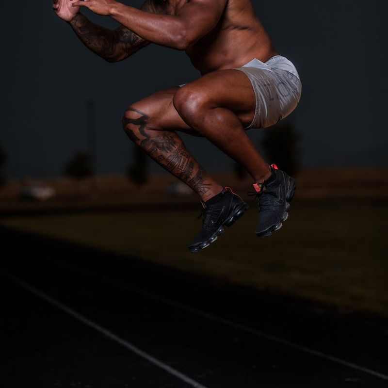 Man in mid-motion during a dynamic strength exercise, showing power.